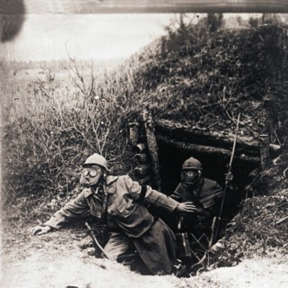 Soldiers in gas masks emerging from trenches, c1914-c1918. Artist: Unknown.