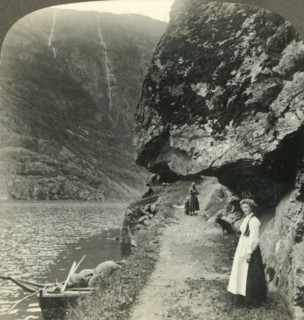 'Where the road creeps under the jutting cliffs by the waters of the Nerofjord, Norway', c1905. Creator: Unknown.