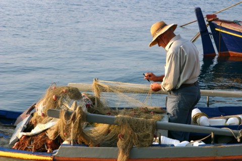 Man on board a fishing boat, Sami, Kefalonia, Greece