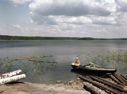 A boy fishing from a rowing boat during his summer holidays, Sweden, 1950s. Artist: Göran Algård