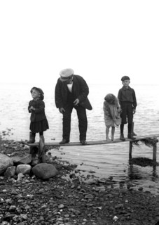 A man with three children on a jetty, Landskrona, Sweden, 1910. Artist: Unknown