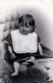 Portrait of a little girl in a big chair, c1910. Artist: Unknown