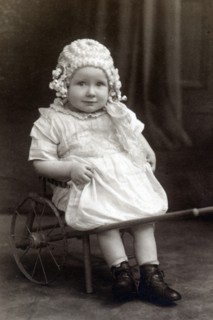 A little girl in a cart, c1910. Artist: Unknown