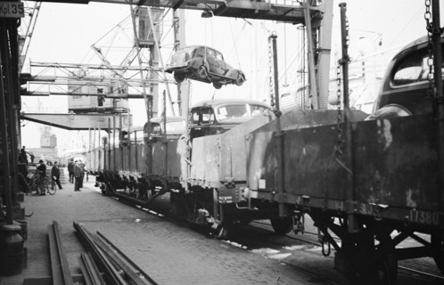 Imported cars being loaded onto railway goods wagons, Landskrona Harbour, Sweden, 1935. Artist: Unknown
