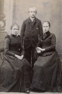 Studio portrait of three siblings, c1900. Artist: Unknown