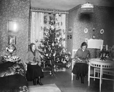 Two women on Christmas Eve with a Christmas tree in front of the window, Sweden, early 1900s. Artist: Unknown