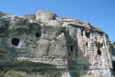 Assyrian rock reliefs pitted by Chr hermit caves, Bavian, Iraq, 1977.
