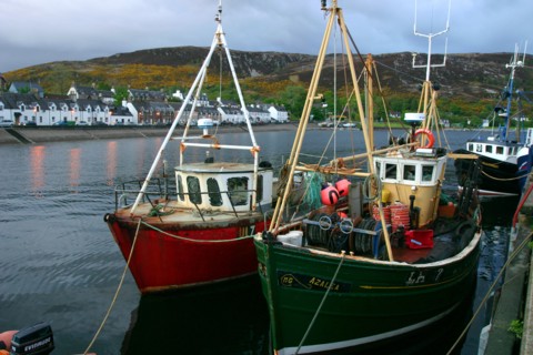Fishing boats in Ullapool harbour at night, Highland, Scotland.