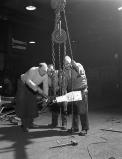 Three workers from Edgar Allen's handle a red hot billet, Sheffield, South Yorkshire, 1963. Artist: Michael Walters