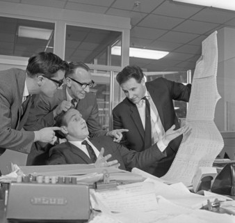 A salesman gets a helping hand in checking the figures, 1967.  Artist: Michael Walters