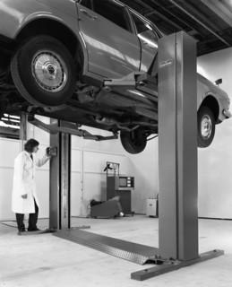 A Ford Zodiac on a Laycock asymmetric lift, 1972.  Artist: Michael Walters