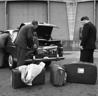 A 1961 Austin Westminster being loaded with luggage on Amsterdam docks, Netherlands 1963. Artist: Michael Walters