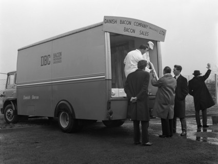 Traders buying bacon direct from a Danish Bacon wholesale van, Kilnhurst, South Yorkshire, 1961. Artist: Michael Walters