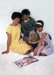 Family group looking at a magazine, 1963. Artist: Michael Walters