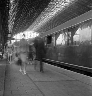 Travellers walking along a platform at Centraal Station, Amsterdam, Netherlands, 1963. Artist: Michael Walters