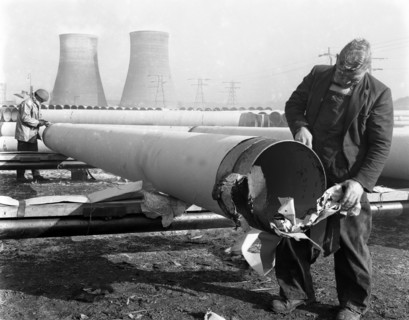 Pipe wrapping to prevent corrosion on steel pipes, Old Denaby, South Yorkshire, 1961. Artist: Michael Walters