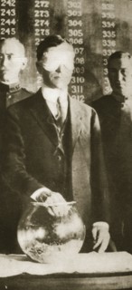 American Secretary of War Newton D Baker drawing the first number in the selective draft, 1917. Artist: Unknown