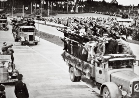 Labourers salute Hitler from packed trucks on a Nazi-built road, 1936. Artist: Unknown