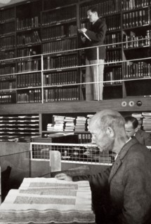 A labourer reads a book in a library, Germany, 1936. Artist: Unknown