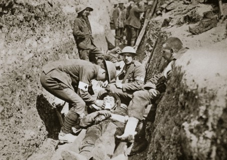 Red Cross men in the trenches tend a wounded man, Somme campaign, France, World War I, 1916. Artist: Unknown