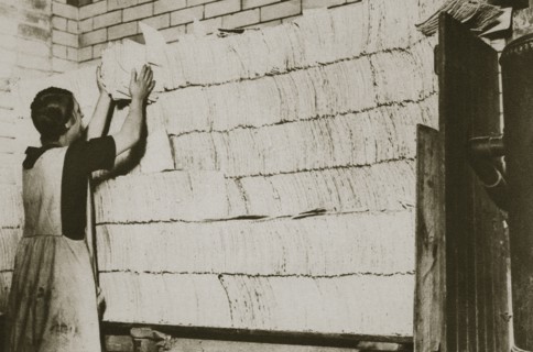 Stacking unleavened bread for the Passover in a Jewish bakery, 20th century. Artist: Unknown