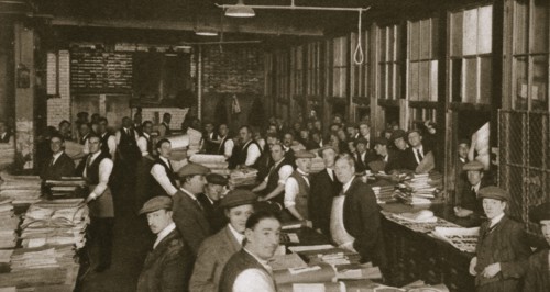 Newsvendors gather to pick up the next day's newspapers to sell, Carmelite House, 20th century. Artist: Unknown