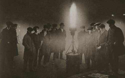 Gathering around an acetylene flare at a traffic control point in the fog, early 20th century. Artist: Unknown