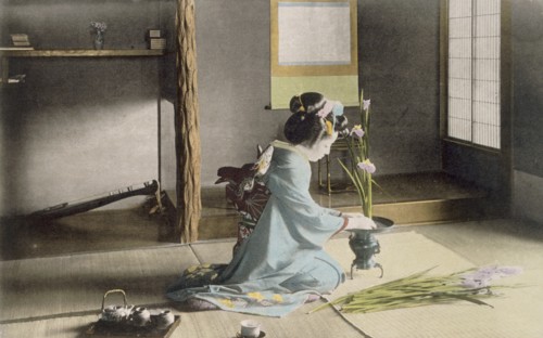 Girl arranging flowers, 1890's. Creator: Japanese Photographer (19th Century).