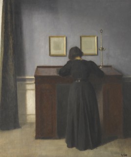 Ida Standing at a Desk. Artist: Hammershøi, Vilhelm (1864-1916)