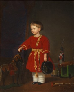 Portrait of a boy in a red dress with military toys.