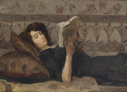Girl reading on a sofa, c. 1920.