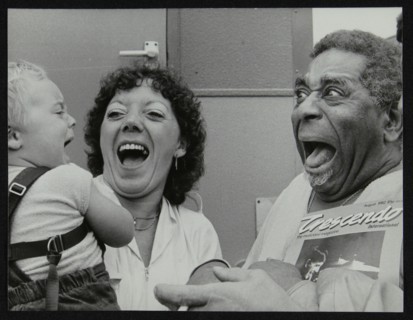 Dizzy Gillespie meeting baby Gary Colfer at Knebworth, Hertfordshire, July 1982. Artist: Denis Williams