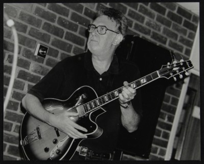 Jim Mullen playing guitar at The Fairway, Welwyn Garden City, Hertfordshire, 3 August 1997. Artist: Denis Williams