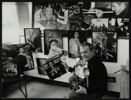 Photographer Denis Williams holding an LP cover. Artist: Unknown