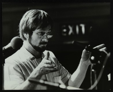 Michael Garrick conducting an orchestra at Berkhamsted Civic Centre, 1985. Artist: Denis Williams