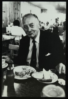 Drummer Max Abrams enjoying a plate of fish and chips in a Soho chip shop, London, 1983. Artist: Denis Williams