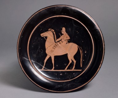 Attic red-figure plate showing a mounted archer in oriental costume in the interior, inscribeld Mil Artists: Unknown, Paseas.