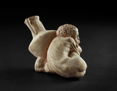 Terracotta figurine of an Afro-Hellenic boy, possibly a slave with Rhodian amphora, 4th century BC. Artist: Unknown.