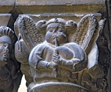 Capital of one of the Gothic galleries of the cloister built between (1387 - 1401) representing a?