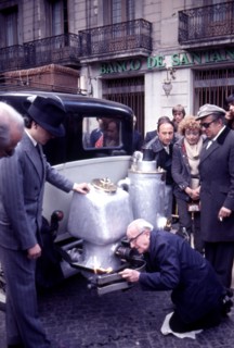 Participants in the rally Barcelona Sitges, period dressed in a car with wood gas generator.