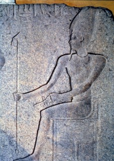 Detail of a stone engraving depicting a priest.