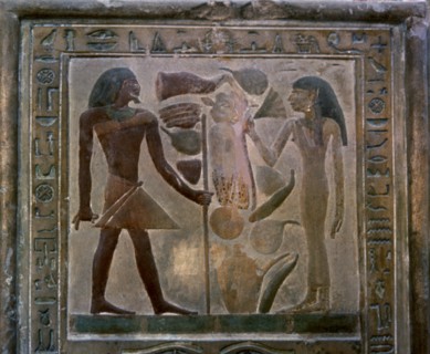 Door shaped stela representing Senouret and his wife in front of their offerings, made in polychr?