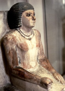 Statue of a seated man, in polychromed limestone.