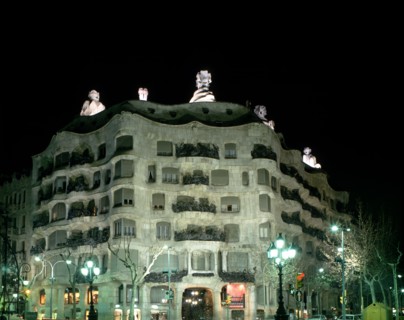 Façade of the Mila House or Pedrera lit at night, by Antoni Gaudí i Cornet (1852 - 1926).