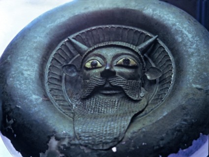 Mask of a river divinity, in bronze.