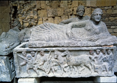 Etruscan stone sarcophagus with reliefs of Eastern influence, with a sculpture of a woman lying o?