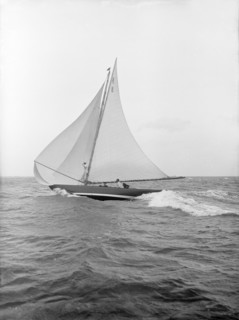 The 7 Metre yacht 'Pinaster' (K8) sailing with spinnaker, 1913. Creator: Kirk & Sons of Cowes.