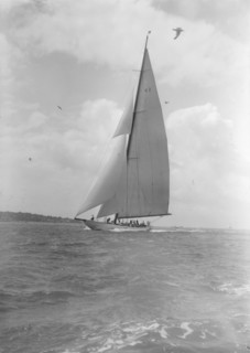 The 23-metre cutter 'Astra' sailing close-hauled, 1933. Creator: Kirk & Sons of Cowes.