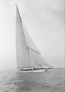 The 23-metre cutter 'Astra' sailing close-hauled, 1933. Creator: Kirk & Sons of Cowes.