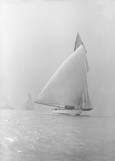The 250 ton schooner 'Germania' running under spinnaker, 1913. Creator: Kirk & Sons of Cowes.